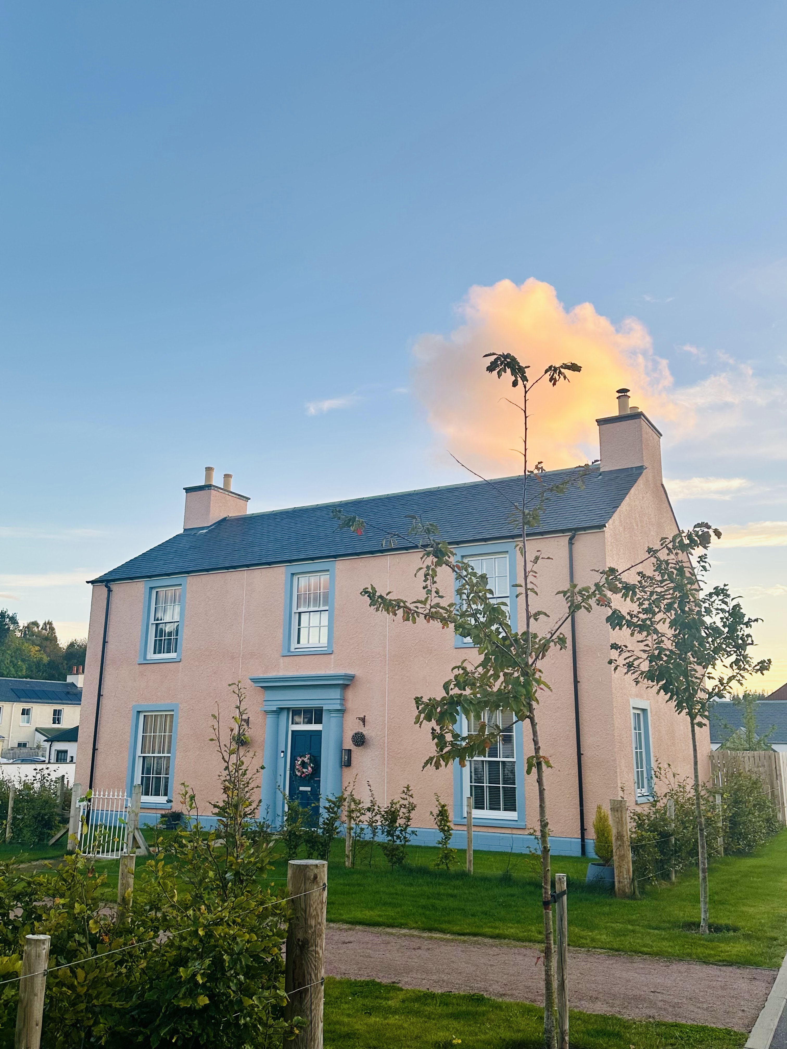 A pink-rendered house on a quiet street in Tornagrain, near Inverness